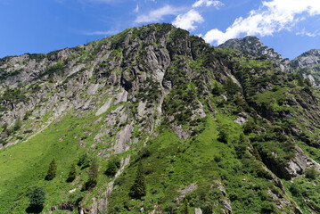 Fototapeta premium Scenic view of rocks and mountains at Schöllenen Gorge, Canton Uri, on a sunny summer day. Photo taken July 3rd, 2022, Schöllenen Gorge, Switzerland.