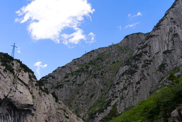 Fototapeta premium Scenic view of rocks and mountains at Schöllenen Gorge, Canton Uri, on a sunny summer day. Photo taken July 3rd, 2022, Schöllenen Gorge, Switzerland.