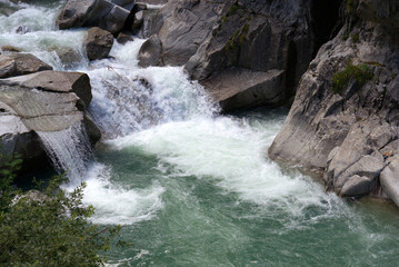 Scenic view of Reuss River at famous Schöllenen Gorge on a sunny summer day. Photo taken July 3rd, 2022, Schöllenen Gorge, Switzerland.