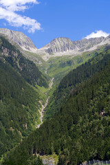 Famous Schöllenen Gorge with rocks, river and mountain panorama in the Swiss Alps on a sunny summer day. Photo taken July 3rd, 2022, Andermatt, Switzerland.