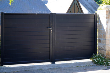 Aluminum black door steel dark gray metal gate of house street portal of suburb access home