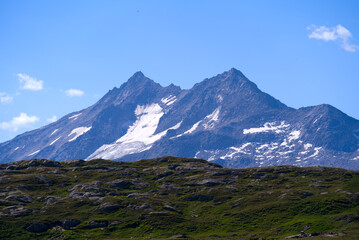 Scenic view of mountain panorama seen from summit of Swiss mountain pass Grimsel on a sunny summer day. Photo taken July 3rd, 2022, Grimsel Pass, Switzerland.