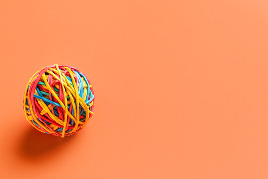 Colorful rubber band ball on color background