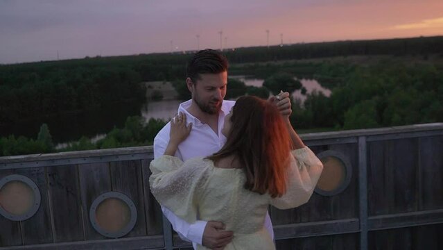 Couple dancing on the sahara tower in Lommel, Belgium at sunset.