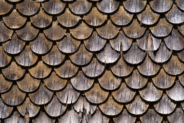 Close-up of wooden shingles facade of historic house at mountain village Göschenen, Canton Uri, on a sunny summer day. Photo taken July 3rd, 2022, Göschenen, Switzerland.