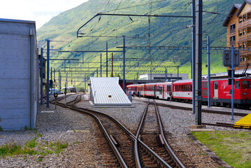 Railway station of Matterhorn Gotthard Railway at mountain village Andermatt, Canton Uri, on a blue...