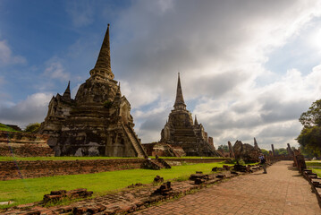 Obraz premium A mature tourist man taking pictures at Wat Phra Sri Sanphe, tourist attraction in Phra Nakhon Si Ayutthaya Province, Thailand