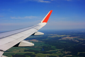 The plane is flying on yellow-green fields