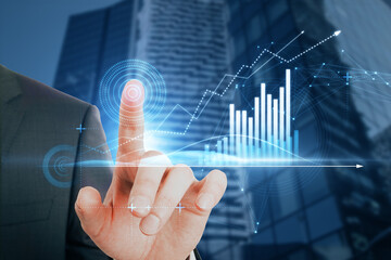 Close up of businessman hand pointing at abstract glowing polygonal business graph hologram with growing arrow on blurry city background. Financial growth, market and trade concept.