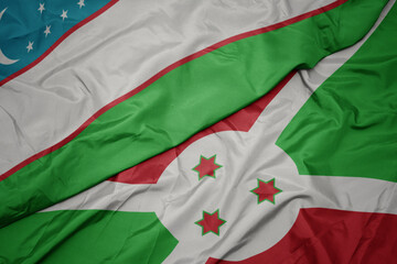 waving colorful flag of burundi and national flag of uzbekistan.