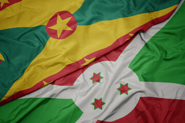 waving colorful flag of burundi and national flag of grenada.