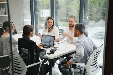 Corporate business team and manager in a meeting room at modern office with panoramic windows. Business concept