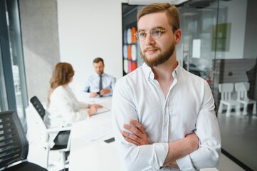 Obraz premium Business man at the office with a group behind him