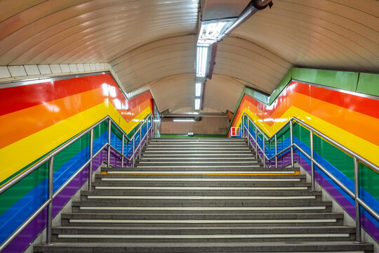 Stairs of the metro station in the Chueca neighborhood of Madrid in awe with the colors of the lgtb rainbow flag