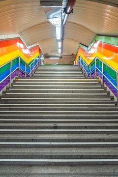 Stairs of the metro station in the Chueca neighborhood of Madrid in awe with the colors of the lgtb rainbow flag