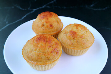 A Plate of Mouthwatering Banana Muffins on Black Marble Stone Table