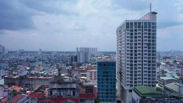 Old communist ,brutalist apartment building in Cho lon  or Chinatown district of Ho Chi Minh City, Vietnam. Sunny view. Long descending crane shot from skyline to ground.