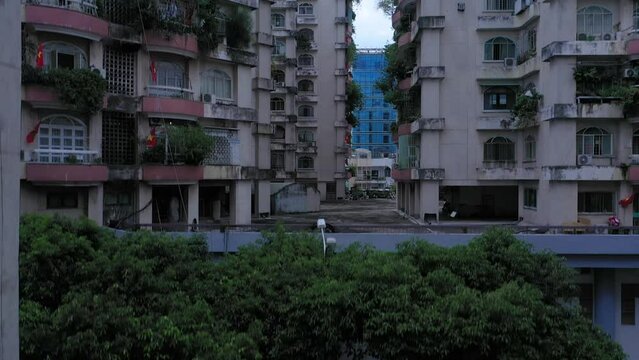 Old communist ,brutalist apartment building in Cho lon  or Chinatown district of Ho Chi Minh City, Vietnam. High angle looking down. Crane shot from ground to rooftops