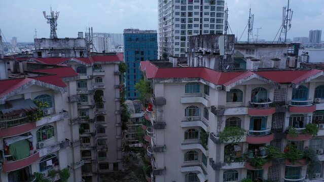 Old communist ,brutalist apartment building in Cho lon  or Chinatown district of Ho Chi Minh City, Vietnam. High angle looking down. Pan right to left over rooftops.