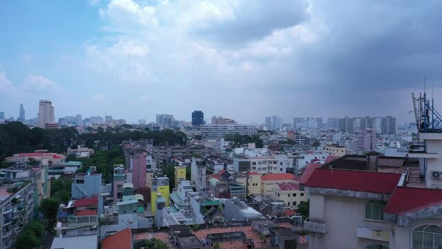 Old communist ,brutalist apartment building in Cho lon  or Chinatown district of Ho Chi Minh City, Vietnam. High angle looking down. Long pan from skyline right to rooftops.