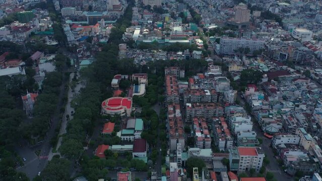 Aerial view from Cho lon or Chinatown district of Ho Chi Minh City, Vietnam. Sunny view. Long tilt shot from skyline to top down view.