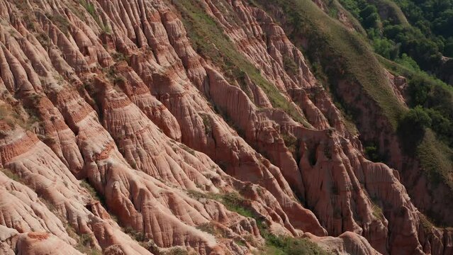 4K aerial view of Rapa Rosie mountain landmark (translated in English - Red Ravine) in Transylvania. Travel landscapes of Romania.