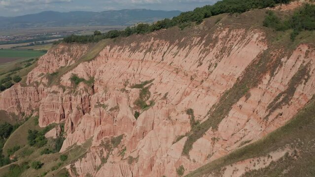 4K aerial view of Rapa Rosie mountain landmark (translated in English - Red Ravine) in Transylvania. Travel landscapes of Romania.