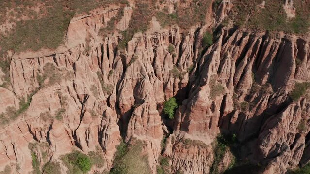 4K aerial view of Rapa Rosie mountain landmark (translated in English - Red Ravine) in Transylvania. Travel landscapes of Romania.