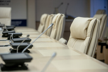 Microphone in seminar room, conference event or press conference Abstract blurred background. News conference. Political debate during answering media questions.