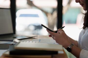 A businesswoman completes KYC using an online banking program in order to open a digital savings...