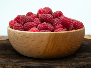 Raspberries in wooden bowl. Raspberry with copy space for text