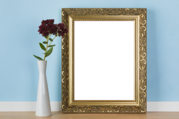 Vertical golden picture frame leaning on blue wall with stonecrop flowers in vase transparent mockup template