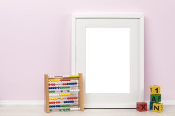 Background mockup template, white vertical transparent picture frame with matte and toddlers toys in front of pink wall