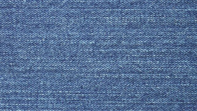 Closeup Macro Blue Denim Jeans Fabric Plain Surface Background. Textile Texture Tracking. Slider Pan Shot.