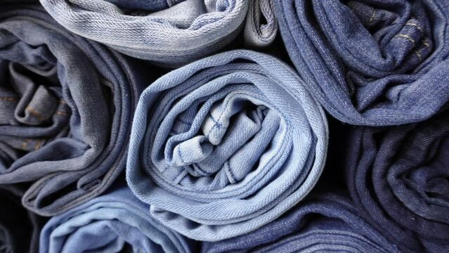 Stack of Various Shades of Rolled Up Denim Jeans