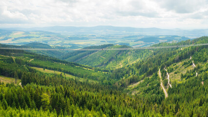 Sky Bridge 721 is the longest suspension bridge between two hills in the forest, Dolni Morava, Czech Republic . One way footbridge in touristic place in the forest in summer. 