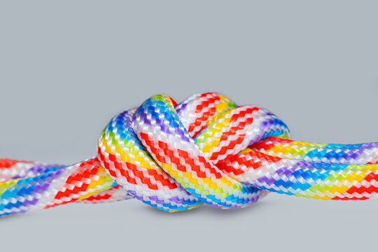 Colored threaded cords knotted together isolated