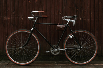 Naklejka na ściany i meble Old bicycle leaning against grungy barn
