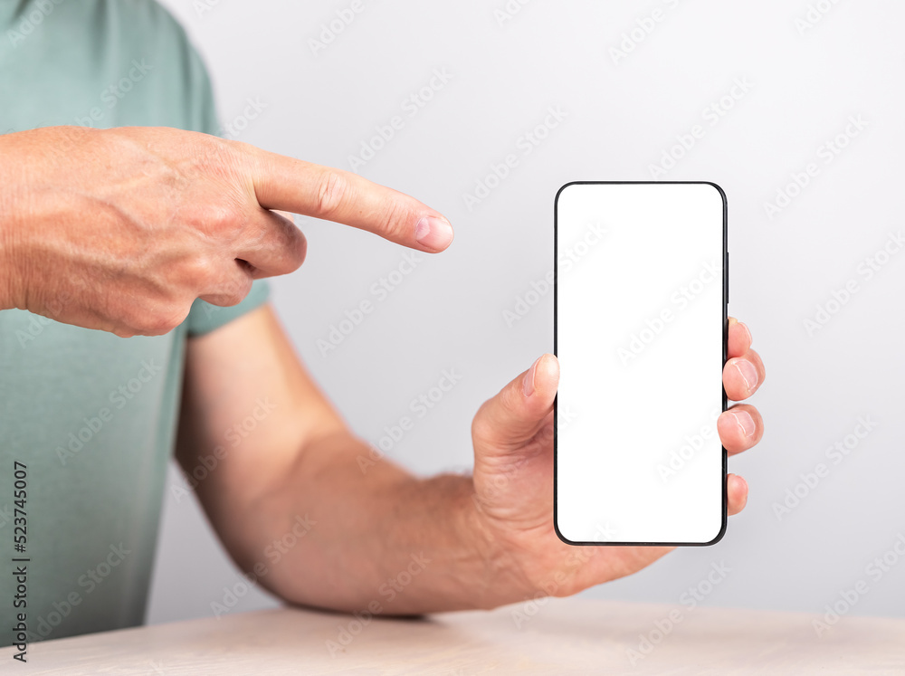 Aufkleber man forefinger pointing to phone mockup in vertical position. male showing or recommending applicati