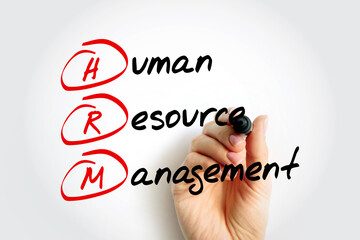 HRM - Human Resource Management is the strategic approach to the effective and efficient management of people in a company or organization, acronym business concept background