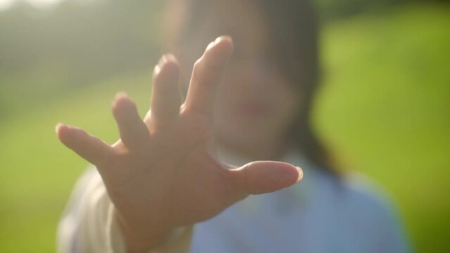 Open Hand Of A Woman Outdoor Closing And Making A Fist. close up, selective focus