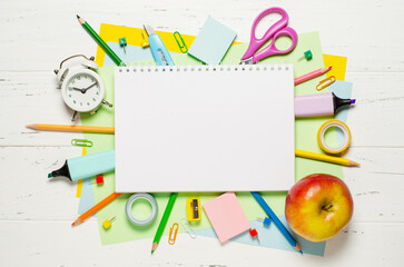 Children's accessories for study, creativity and office supplies on a white wooden background. Back to school concept. Copy space
