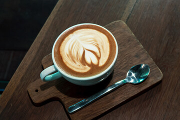 White cup of tasty cappuccino with art latte.