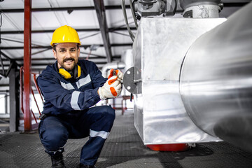 Portrait of smiling caucasian worker working in heating energy plant.