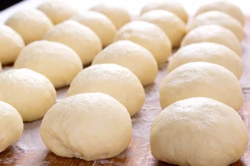 Fotobehang Yeast dough balls on the wooden board with flour. Preparing to bake buns, pizza or bread © kcuxen