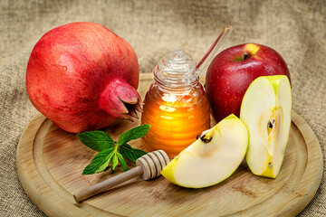 Rosh Hashanah. Pomegranate, apple and honey, traditional food for Jewish New Year celebration, Rosh Hashanah.