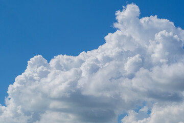 A huge white fluffy cloud in the blue sky