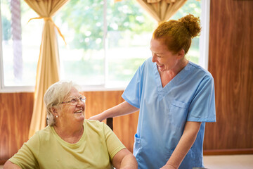 Nurse and senior laugh together