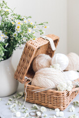 wicker basket with yarn and needles on white background.