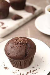 Delicious cupcake with chocolate crumbles on plate, closeup